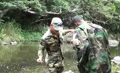 Two military lads resting by the river